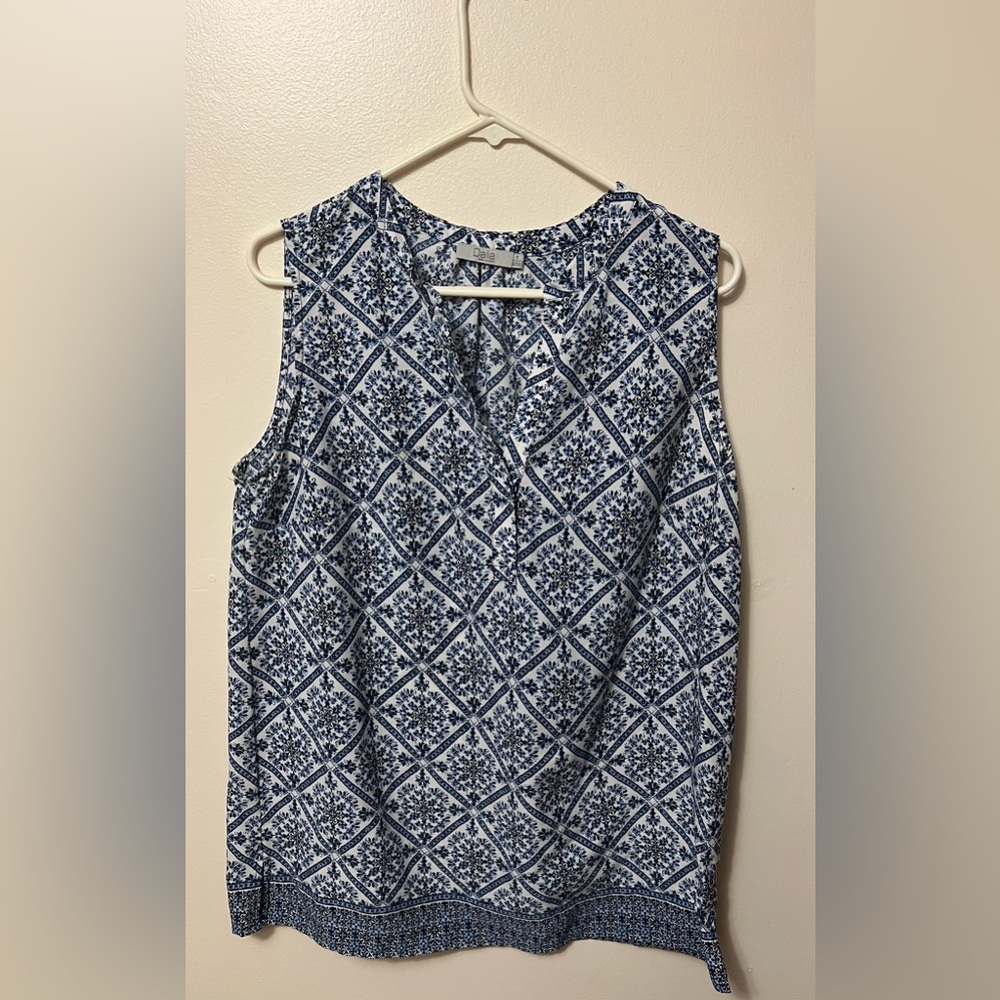 Women’s sleeveless top. Blue and white, 100% polyester, size Large.